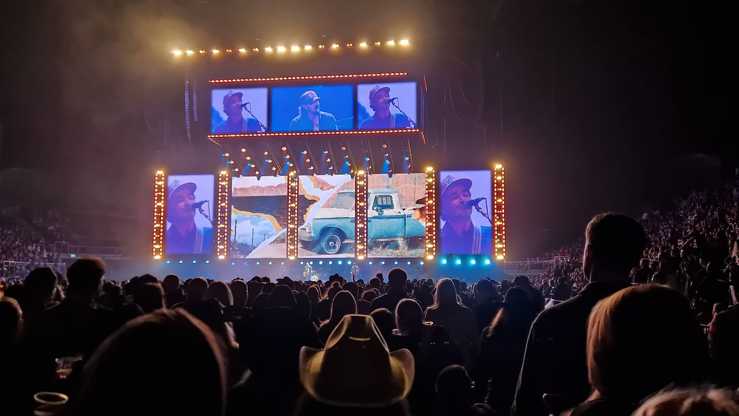 Audience view of IMAG screens and a pickup-truck look on the centre LED, Country 2 Country Festival, O2 Arena, March 2025.