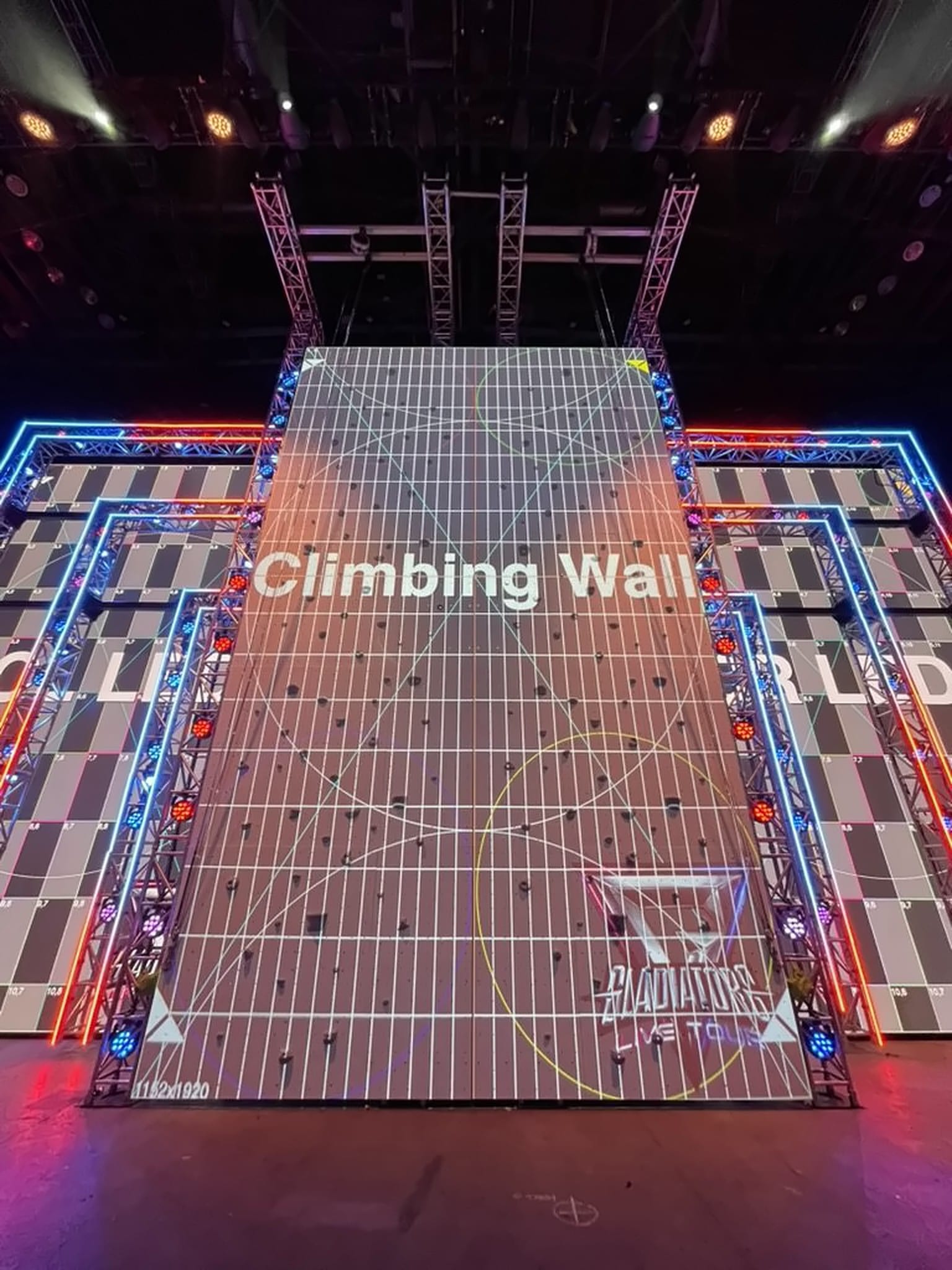 Climbing-wall LED during setup, resolution marked 1152 by 1920, flanked by LED screens, Gladiators Live Tour 2025.