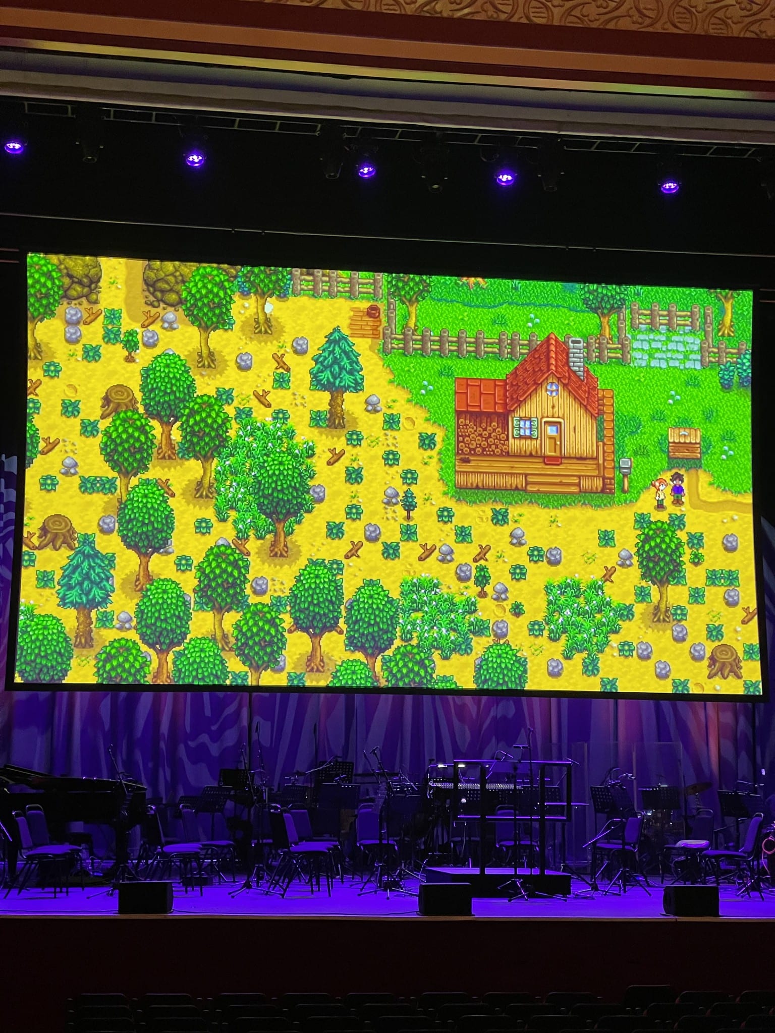 Orchestra under Stardew Valley farm gameplay on the main screen, UK tour, February 2026.